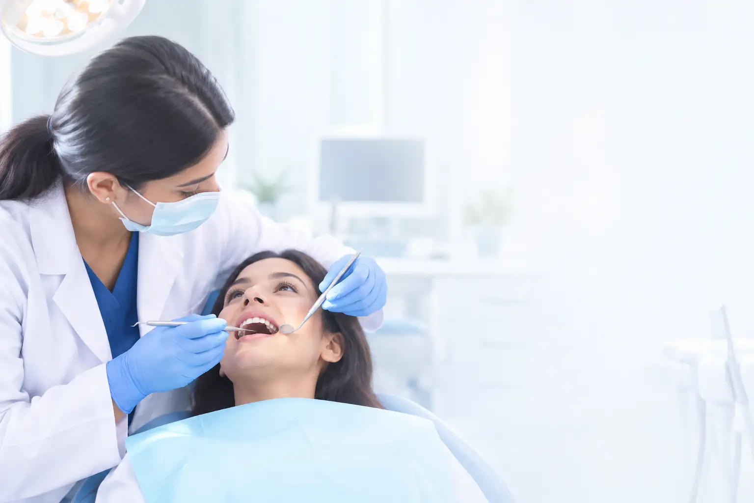A-dentist-wearing-a-mask-and-gloves-examines-a-smiling-woman’s-teeth-with-dental-instruments-in-a-bright-modern-dental-clinic.