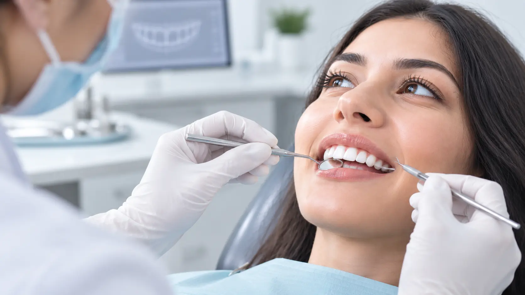 smile-design-treatment-dentist-examining-patients-smile-with-dental-instruments